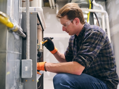 technician inspecting a furnace